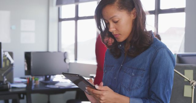 Woman Using Tablet in Modern Office with Natural Light - Download Free Stock Images Pikwizard.com