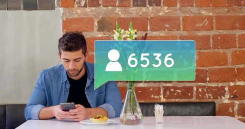 Man increasing social media followers using phone at cafe