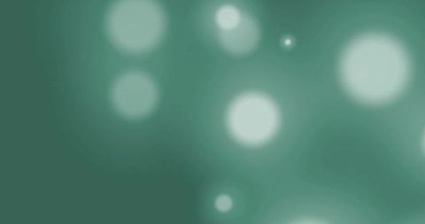Abstract green background with floating light spots