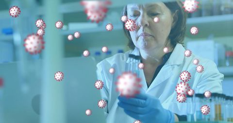 Laboratory researcher examining sample surrounded by coronavirus cells