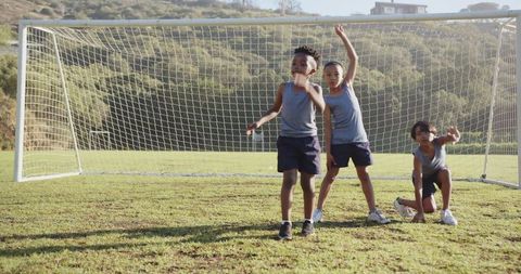 Young Athletes Practicing Kick Drills on Lush Soccer Field