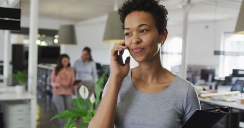 Confident Businesswoman Making Call in Modern Office