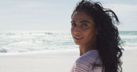 Smiling Woman Outdoors by Ocean Waves on Sunlit Sands