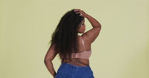 Confident African American Woman Posing in Minimalist Studio