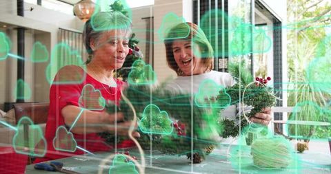 Mother and daughter crafting holiday wreaths exploring augmented reality cloud overlay