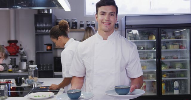 Smiling Chef Presenting Dishes in Professional Kitchen - Download Free Stock Images Pikwizard.com