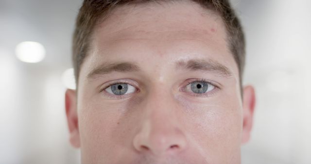 Image captures a close-up of a person's blue eyes staring intensely. Useful for themes of focus, determination, human emotion, and personal connection. Perfect for psychological articles, confidence boost materials, or any content needing a strong, engaging visual.