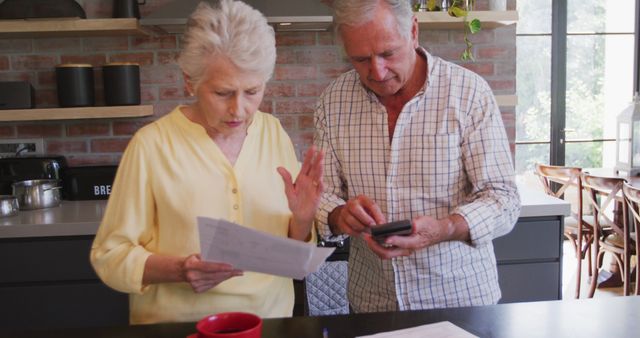Senior Couple Analyzing Finances in Modern Kitchen - Download Free Stock Images Pikwizard.com