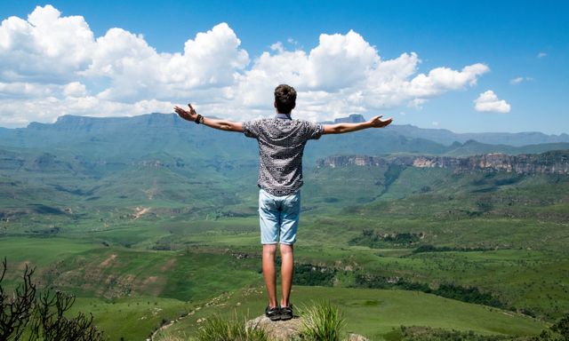Man enjoying mountain view with open arms in summer - Download Free Stock Photos Pikwizard.com