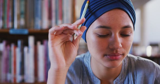 Thoughtful Woman Holding Pencil in Library - Download Free Stock Images Pikwizard.com