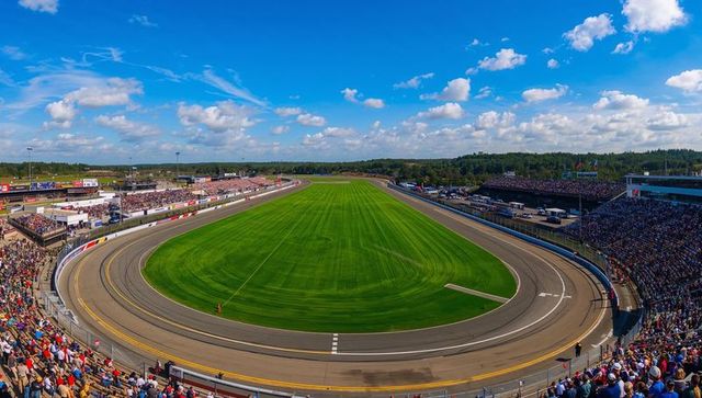 Crowded grandstands at asphalt oval track ready for motorsport event