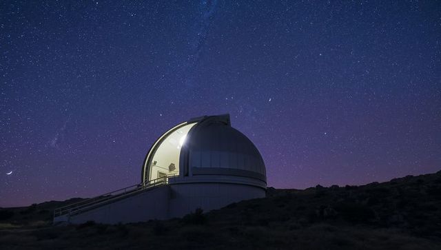Observatory gazing at stardust sky with bright celestial bodies