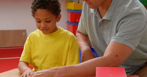 Young Teacher Engaging with Young Student in Classroom Setting - Download Free Stock Images Pikwizard.com
