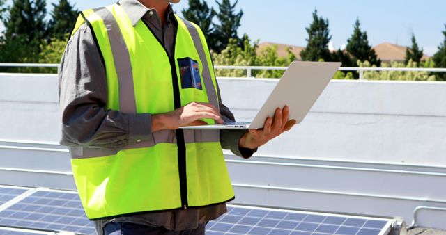 Engineer Inspecting Solar Panels on Rooftop with Laptop - Download Free Stock Images Pikwizard.com