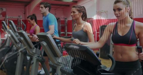 Group Exercising on Ellipticals in Modern Gym Setting