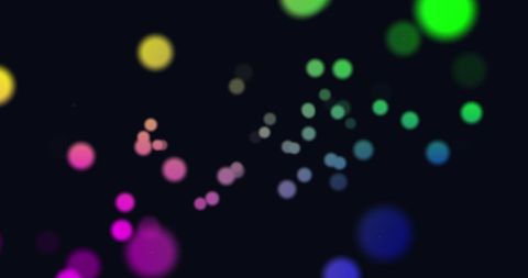 Colorful Glowing Spots on Black Background in Hypnotic Motion