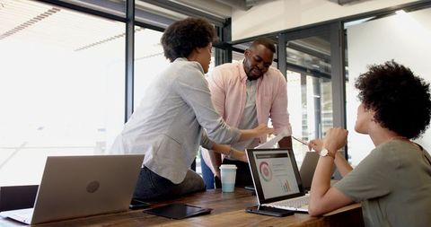 Diverse Team Collaboration in Modern Office Reviewing Reports