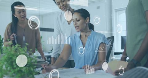 Diverse team collaborating with digital analytics in modern office