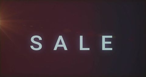 Glowing sale lettering announcing limited-time discount with cinematic lens flare vignette