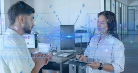 Colleagues Collaborating with Technology in Modern Office Environment