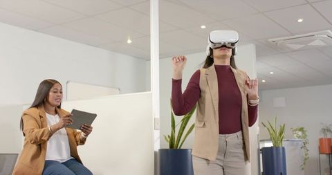 Coworkers engaging with modern technology in office environment