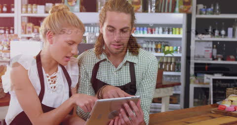 Coworkers Analyzing Financial Data on Tablet in Store