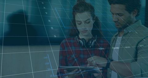 Young professionals collaborating over tablet with digital overlays and analytics visualization