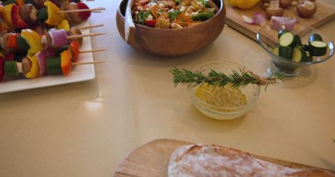 Fresh vegetable skewers and salad preparation in rustic kitchen