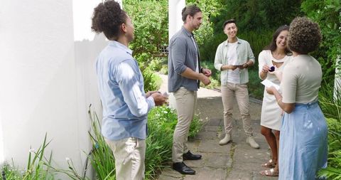 Friends laughing and chatting in sunlit garden