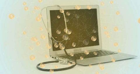 Bitcoin Symbols Floating Over Laptop and Stethoscope in Healthcare Concept
