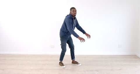 Man Practicing Dance Moves in Minimalist Space