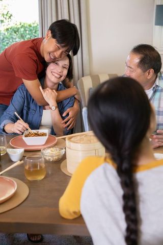 Diverse Family Joyfully Dining Together at Cozy Home Gathering