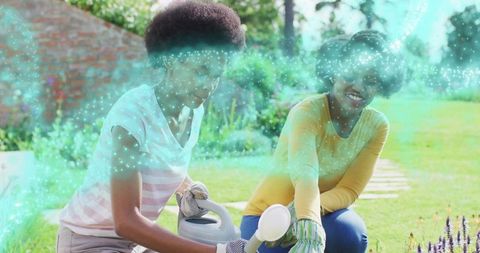 Mother and Teen Gardening Together in Sunny Backyard Tending Lavender and Flowers