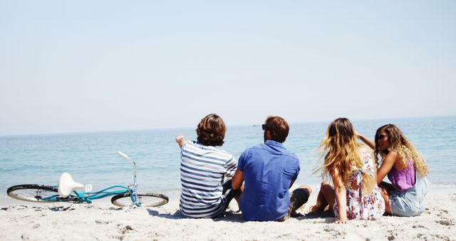 Friends Relaxing on Beach with Bicycle by the Shore - Download Free Stock Images Pikwizard.com