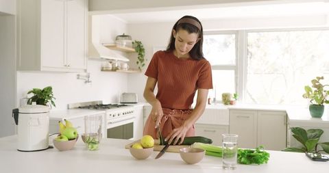 Young Woman Preparing Fresh Ingredients in Modern Kitchen