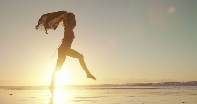 Silhouette of Woman Jumping on Beach at Sunset - Download Free Stock Images Pikwizard.com