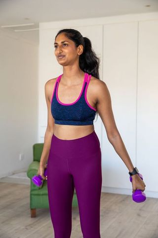 Indian Woman Exercising with Dumbbells at Home for Wellness