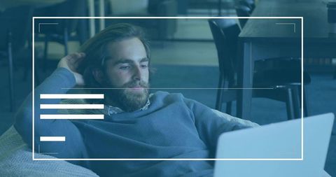 Professionally relaxed worker focusing on laptop in minimalist lounge