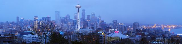 Seattle’s downtown skyline is featuring prominently at dusk, with the iconic Space Needle standing tall. The city lights are beginning to illuminate against the early evening sky. This serene cityscape image is perfect for travel blogs, websites promoting Seattle tourism, city guides, urban development presentations, and architectural reviews.