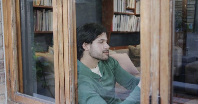 Pensive Man Gazing Through Wooden Window in Library - Download Free Stock Images Pikwizard.com