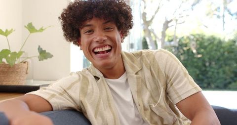 Cheerful Young Man Relaxing at Home with a Happy Smile