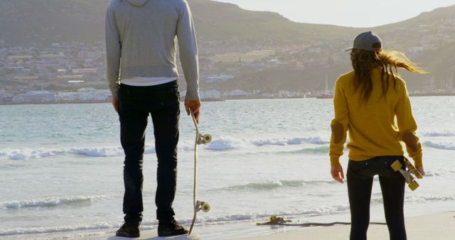 Couple with Skateboards by Ocean - Download Free Stock Images Pikwizard.com