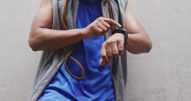 Person Checking Smartwatch During Workout Session with Jump Rope - Download Free Stock Images Pikwizard.com