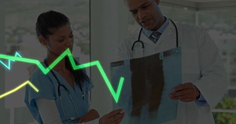 Medical Team Analyzing X-Ray with ECG Monitoring in Clinical Setting