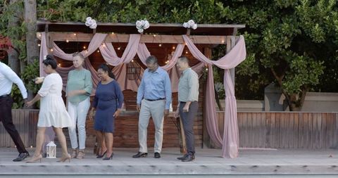 Group of Friends Celebrating Wedding in Garden Setting