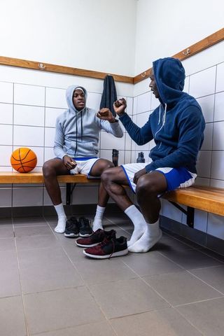 Teen Basketball Players Fist Bumping in Locker Room