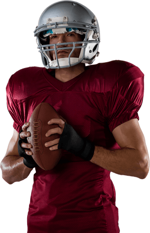 Determined football player holding transparent ball in burgundy jersey
