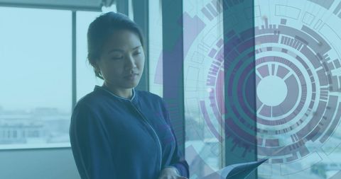 Asian Businesswoman Analyzing Digital Financial Data in Modern Office