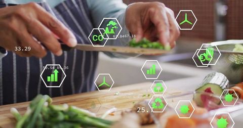 Senior woman chopping herbs with overlays tracking co2, energy and sustainability metrics