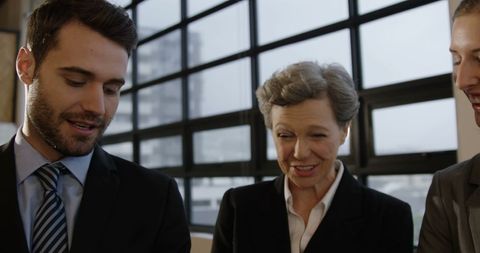 Business Professionals Engaging in Conversation Inside Modern Office